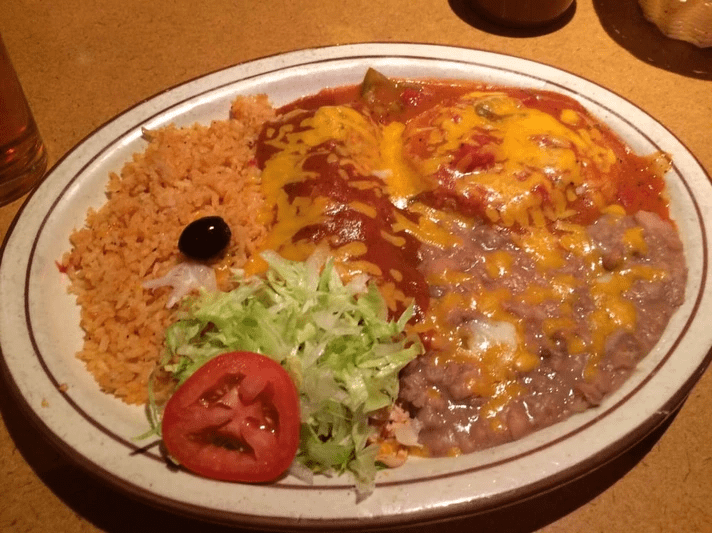 Enchilada meal with rice and beans.